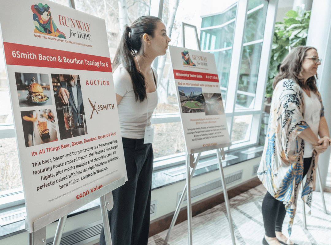 Volunteer standing near banner