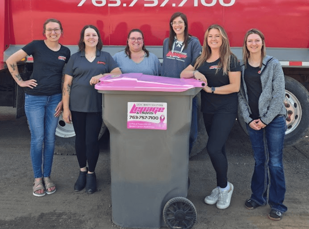 ladies by trash container with pink lid